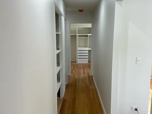Crisp white painted hallway with timber floors